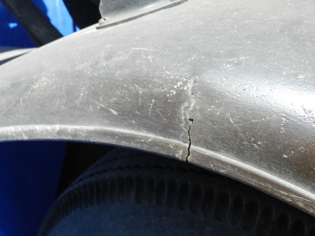 A crack in the right rear fender, probably caused by jarring from the bumpy roads